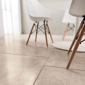 Contemporary dining area with beige stone look porcelain tile