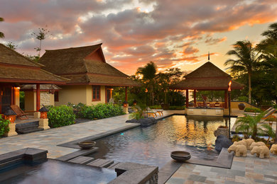 Inspiration for a mid-sized zen stone and rectangular infinity hot tub remodel in Hawaii