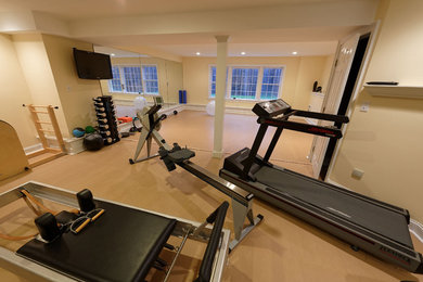 Large traditional multipurpose gym in Chicago with yellow walls, light hardwood floors and beige floor.