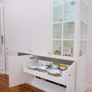 Large traditional kitchen pantry ideas - Kitchen pantry - large traditional u-shaped medium tone wood floor and beige floor kitchen pantry idea in Hobart with a farmhouse sink, shaker cabinets, white cabinets, granite countertops, white backsplash, subway tile backsplash, stainless steel appliances, no island and white countertops
