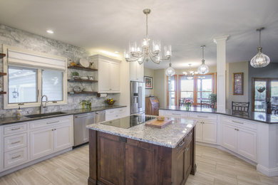 Mid-sized farmhouse ceramic tile and beige floor kitchen photo in Kansas City with a double-bowl sink, recessed-panel cabinets, granite countertops, gray backsplash, marble backsplash, stainless steel appliances and two islands