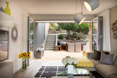 Living room - mid-sized transitional open concept light wood floor living room idea in San Francisco with white walls, no fireplace and a wall-mounted tv
