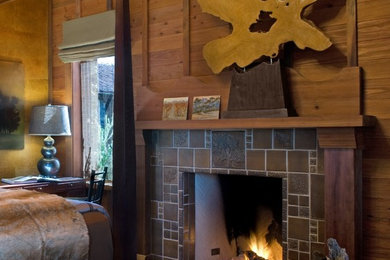 Mid-sized mountain style bedroom photo in San Francisco with brown walls, a standard fireplace and a tile fireplace