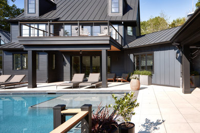 Inspiration for a contemporary black three-story mixed siding and clapboard house exterior remodel in DC Metro with a black roof