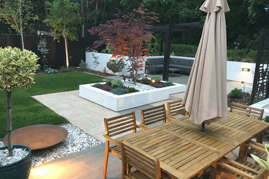 Trendy backyard tile patio photo in Other with a pergola
