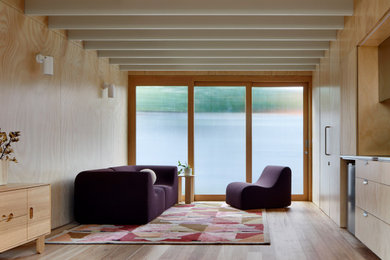 Design ideas for a small modern loft-style living room in Melbourne with beige walls, light hardwood floors, beige floor and exposed beam.