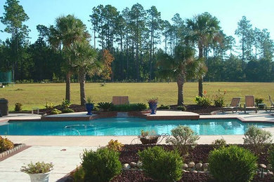 This is an example of a large backyard rectangular pool in Atlanta with concrete pavers.