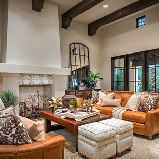 Imagen de salón abierto, mediterráneo, grande, con chimenea tradicional, marco de chimenea de baldosas y/o azulejos, paredes beige, suelo de madera en tonos medios y suelo marrón