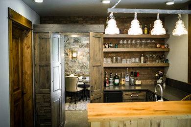 Inspiration for a mid-sized rustic l-shaped concrete floor and brown floor seated home bar remodel in Other with open cabinets, dark wood cabinets, quartz countertops and brick backsplash