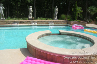 Custom shaped swimming pool in Charlotte with concrete slabs.