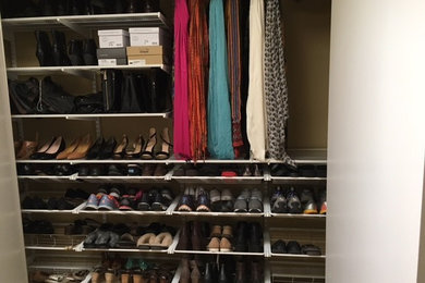 Example of a mid-sized classic women's reach-in closet design in Dallas with open cabinets and white cabinets