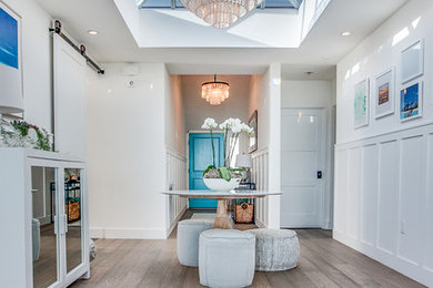 Inspiration for a coastal foyer remodel in Los Angeles with white walls