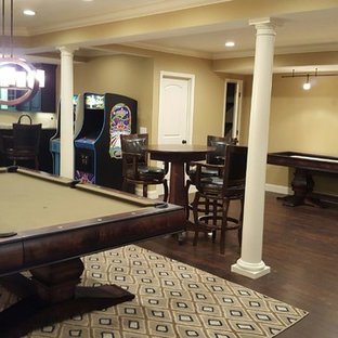 Design ideas for a large classic basement in St Louis with yellow walls and dark hardwood flooring.