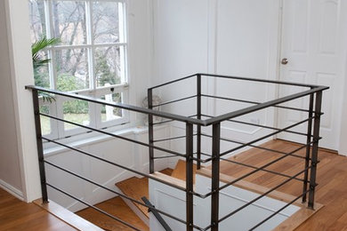 Design ideas for a large modern wood spiral staircase in Other with painted wood risers and metal railing.
