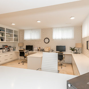 Large transitional study room in Toronto with multi-coloured walls, travertine floors, no fireplace, a built-in desk and beige floor.