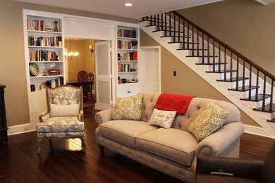 Example of a large classic formal and open concept dark wood floor and brown floor living room design in DC Metro with yellow walls, a standard fireplace, a wood fireplace surround and a wall-mounted tv