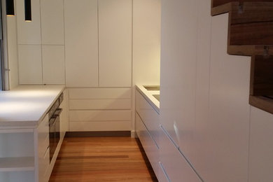 Inspiration for a contemporary kitchen in Sydney with white cabinets.