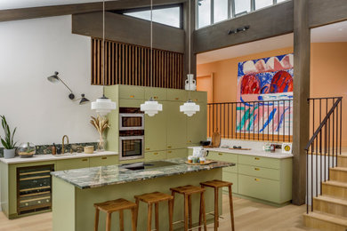 This is an example of a large midcentury l-shaped open plan kitchen in London with a single-bowl sink, flat-panel cabinets, green cabinets, marble worktops, green splashback, marble splashback, stainless steel appliances, light hardwood flooring, an island, green worktops, exposed beams and feature lighting.