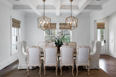Inspiration for a beach style dining room in Charleston with white walls and dark hardwood floors.