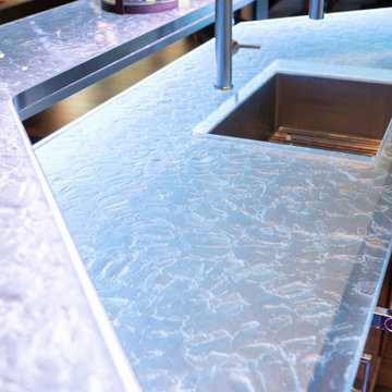 Glass private bar and glass stair treads inside a man cave in Michigan
