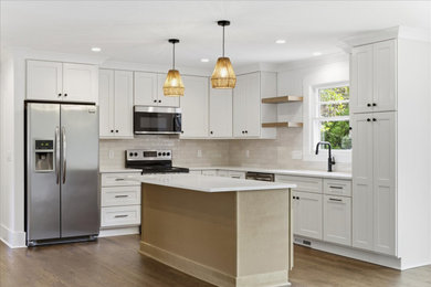 Inspiration for a large timeless l-shaped open concept kitchen remodel in DC Metro with a drop-in sink, shaker cabinets, quartz countertops, subway tile backsplash, stainless steel appliances, an island and white countertops