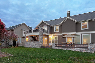 Example of a huge arts and crafts backyard outdoor kitchen deck design in Kansas City with no cover