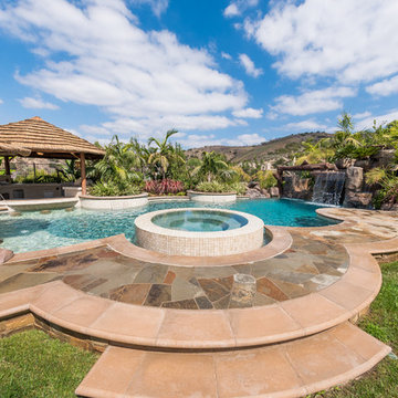 Tropical Beach Entry Pool & Spa with a Rock Slide & Grotto