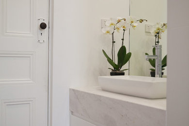 Bathroom in Melbourne with gray tile, white walls, marble floors, a vessel sink and marble benchtops.