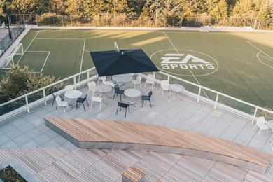 Photo of a large contemporary full sun rooftop landscaping in Vancouver with decking for summer.