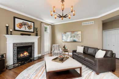 Inspiration for a large contemporary medium tone wood floor and brown floor living room remodel in Detroit with beige walls, a standard fireplace and a tile fireplace