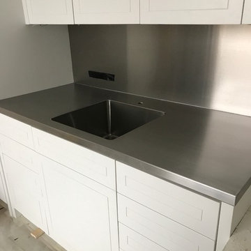 Nice little laundry room stainless counter with a welded in sink and backsplash