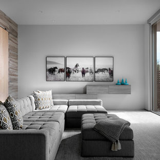 This is an example of a large modern enclosed home cinema in Las Vegas with a wall mounted tv.