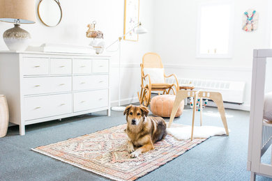 Example of a large eclectic gender-neutral carpeted nursery design in Boston with white walls