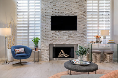 Large trendy open concept porcelain tile and beige floor family room photo in Phoenix with gray walls, a standard fireplace, a stone fireplace and a media wall