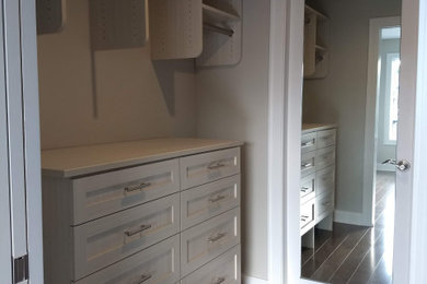 Mid-sized transitional women's medium tone wood floor and brown floor walk-in closet photo in New York with shaker cabinets and light wood cabinets