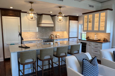 Mid-sized transitional dark wood floor, brown floor and coffered ceiling eat-in kitchen photo in Boston with an undermount sink, recessed-panel cabinets, white cabinets, granite countertops, beige backsplash, granite backsplash, paneled appliances, an island and beige countertops