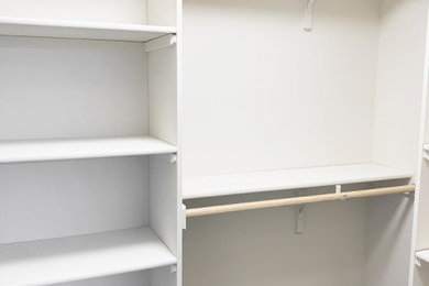 Example of a minimalist closet design in Other