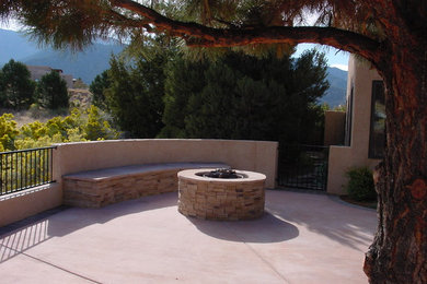 Mid-sized traditional backyard patio in Albuquerque with a fire feature, natural stone pavers and no cover.