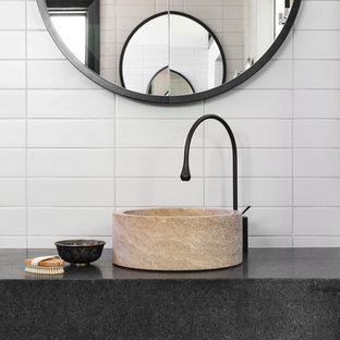 シドニーのコンテンポラリースタイルのおしゃれなトイレ・洗面所 (ベッセル式洗面器、白いタイル、サブウェイタイル、グレーの洗面カウンター) の写真