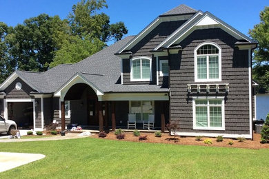 Large traditional brown two-story wood house exterior idea in Phoenix with a clipped gable roof and a shingle roof