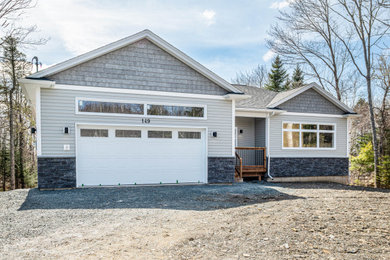 Contemporary gray mixed siding house exterior idea in Other with a gray roof