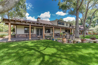 Mid-sized elegant beige one-story wood exterior home photo in Houston with a shingle roof
