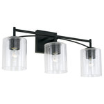 Capital Lighting - Peyton Three Light Vanity, Matte Black - The sharp lines and artistic arches of the Peyton 3-Light Vanity give a modern update to old world influence. The muted tone of the Matte Black finish allows the seeded glass shade to take center stage.