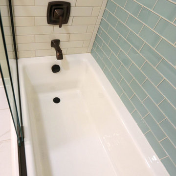 Guest Bathroom with Cherry Vanity, Venetia Cream Countertop, Tiled Shower Walls