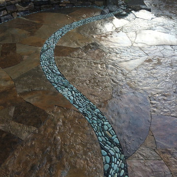 Dry laid patio with pebble stream and waterfall