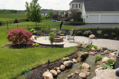 Inspiration for a large traditional backyard stone landscaping in New York.