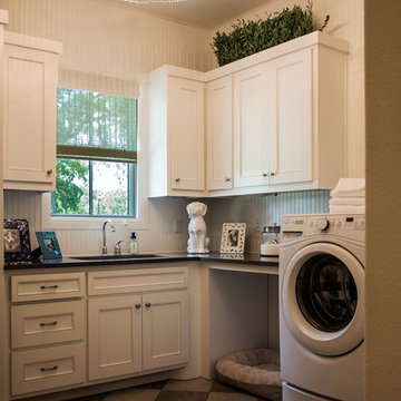 White launrdy with dog bed and flat panel doors
