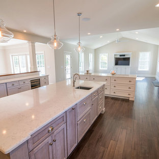 Huge transitional kitchen pantry appliance - Inspiration for a huge transitional l-shaped medium tone wood floor kitchen pantry remodel in Providence with white cabinets, granite countertops, beige backsplash, stone tile backsplash, white appliances, a farmhouse sink, recessed-panel cabinets and two islands