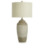 StyleCraft - Charlotte Taupe Polyresin Table Lamp Speckled Finish Sand Linen Shade - This lamp is specially designed to spice up your room by incorporating texture and dimension into your space. This piece is made from polyresin and has a distressed speckled cream finish giving it a rustic feel. Place along side a variety of home decor with its easy to style neutral color palette.