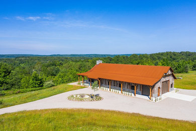 Mountain style wood house exterior photo in Other with a metal roof